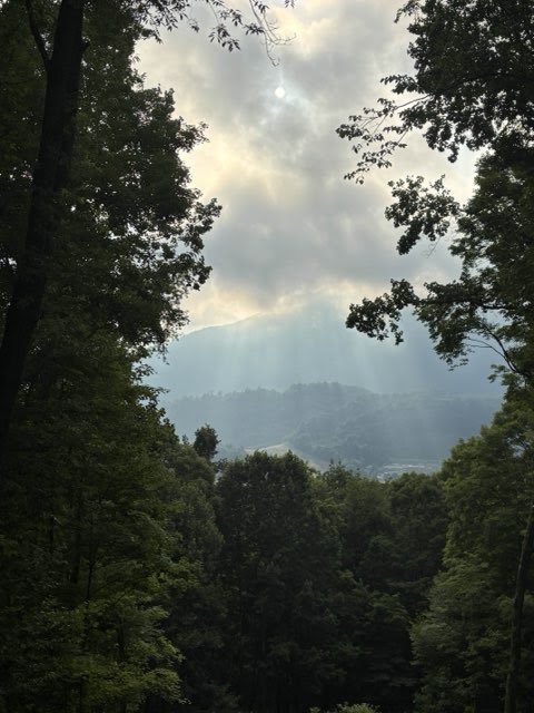 Sun rays breaking through clouds over Mount Jefferson